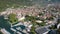 Aerial view of port city in sunny weather in summer, drone is flying up, showing panorama of town