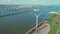 Aerial view of Port of Rotterdam, wind turbines along the North Sea coast on a sunny day