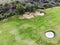 Aerial view of pound on golf course with player.