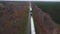 Aerial view. A powerful tractor pulls oversized cargo. A huge metal column for the chemical industry.