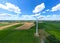 Aerial view of powerful Wind turbine farm for energy production on beautiful cloudy sky at highland. Wind power turbines