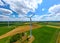 Aerial view of powerful Wind turbine farm for energy production on beautiful cloudy sky at highland. Wind power turbines