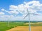 Aerial view of powerful Wind turbine farm for energy production on beautiful cloudy sky at highland. Wind power turbines