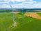 Aerial view of powerful Wind turbine farm for energy production on beautiful cloudy sky at highland. Wind power turbines