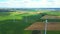 Aerial view of powerful Wind turbine farm for energy production on beautiful cloudy sky at highland. Wind power turbines