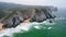 Aerial view of Praia da Adraga beach. Cliff coast of Atlantic ocean. Sintra, Portugal