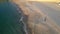 Aerial view of Praia da Torre sandy beach at sunset in Portugal