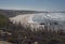 Aerial view of Praia do Brejo Largo beach with two distant hikers figures, ocean waves and sharp stones, cliffs and sand