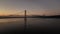 Aerial view of predawn sky over long suspension bridge