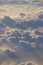 Aerial View of Puffy Sunlit Clouds from an Airplane