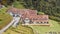 Aerial view of a quaint cottage nestled in the rolling hills of Cameron Highlands, Malaysia.