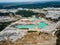 Aerial view quarry extraction porcelain clay, kaolin, with turquoise water