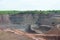 Aerial view into a quarry mine of porphyry rocks.