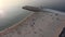 Aerial view of quiet beach with calm ocean and few people. Barra beach from Aveiro, Portugal.