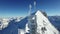 Aerial view of radio antenna tower standing on high snow mountain