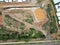 Aerial View of a ragged area with a large pothole and green trees