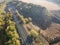Aerial view railroad in autumn forest in foggy sunrise. Top view rural railway