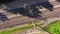 Aerial view of railroad with train in sunny summer day in forest. Top view of cargo with industrial products. Logistics