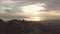 Aerial view of rainforest on the mountain, clouds, ocean and islands at sunrise.