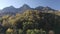 Aerial view raising up over beautiful natural sunny mountain landscape village resort landmark