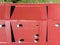 Aerial view of red corrugated metal roof with ventilation system