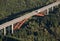 Aerial view : Red highway bridge crossing a forest