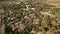 Aerial view of red houses rooftops with green grass and trees in the suburb