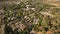 Aerial view of red houses rooftops with green grass and trees in the suburb of israel