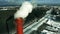 Aerial view of a red industrial smokestack in winter