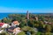 Aerial view at red lighthouse, at baltic sea coast with forest and buildings.