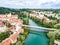 Aerial view of red roofs of Novo Mesto. Slovenia. Krka River. Historic Kandija iron bridge.