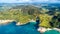 Aerial view on a remote ocean coast with small coves and mountains on the background. Coromandel, New Zealand.