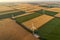 Aerial view of renewable windmills turbines supplying cultivation area with eco power getting energy from wind blowing on vast