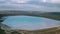 Aerial view of a reservoir full of blue toxic sludge
