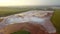 Aerial view of a reservoir full of red toxic sludge