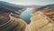 aerial view of a reservoir with very low water levels due to drought and rain shortage on a sunny day