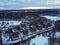 Aerial view of residental complex Novogorsk Olympic village in the evening at sunset. River like a border, beautiful