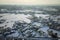 Aerial view of residential houses with snow covered roofops in suburban rural town area in winter