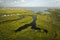 Aerial view of residential suburbs with private homes located near wildlife wetlands with green vegetation on sea shore