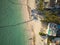 Aerial view of the resort town on the seashore. Lots of tropical plants, hotels, swimming pools, clear turquoise sea. Advertising