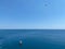 Aerial view of a rib boat with snorkelers and divers at the turquoise colored coast of the Aegean Sea in Greece