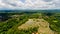 Aerial view of rice terrace filled water, mirroring sky clouds and palm trees.