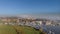 An aerial view of a river marina with majestic church in the backgound under a beautiful foggy blue sky