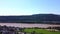 Aerial view of the River Rhine and the hills of a winery in western Germany and a small village in between, 360 degree rotation.