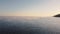 Aerial view of river or sea in the early morning. Water surface with waves and fog. Buoys on a lake. Fishermen fishing