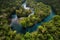 aerial view of river winding its way through the lush jungle, with glimpses of hidden secrets and mysteries