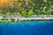 Aerial view of road in beautiful green forest and sea in spring