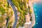 Aerial view of road, boats and yachts, buildings at sunset