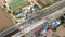 Aerial view of road construction in Asia at two lane bridge; camera rise