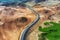 Aerial view on road in Iceland. Aerial landscape above highway in the geysers valley. Icelandic landscape from air. Famous place.